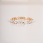 Close up shot of half eternity diamond ring in yellow gold.
