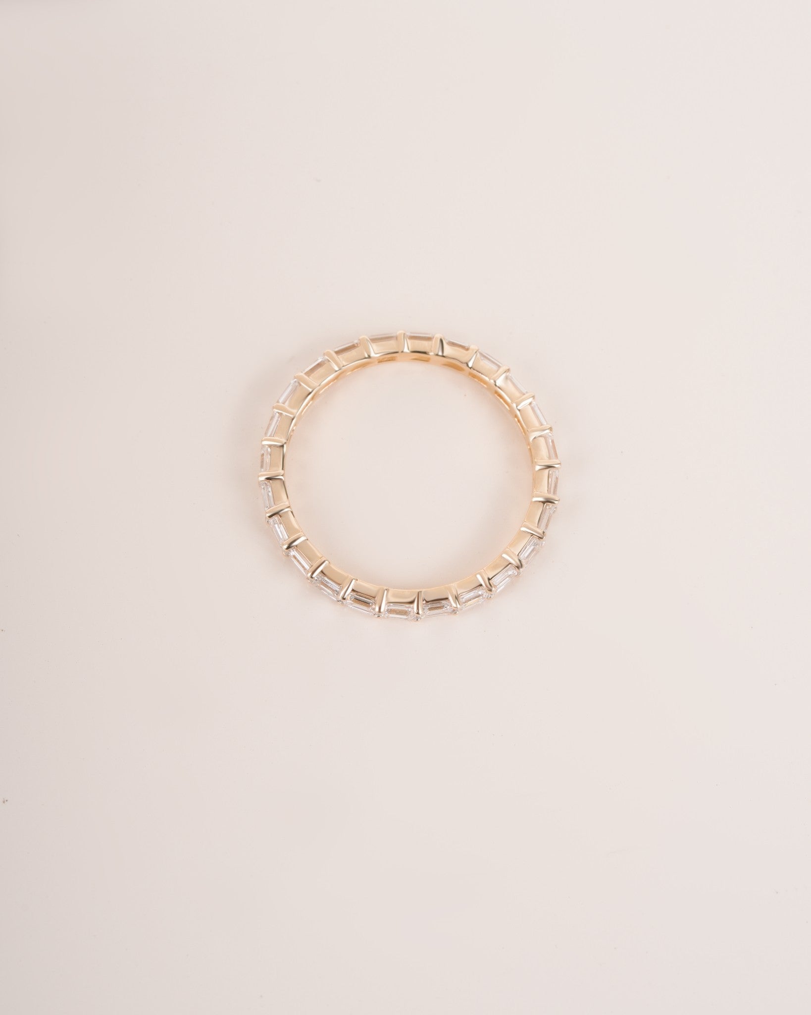 Close up shot of half eternity diamond ring in yellow gold.