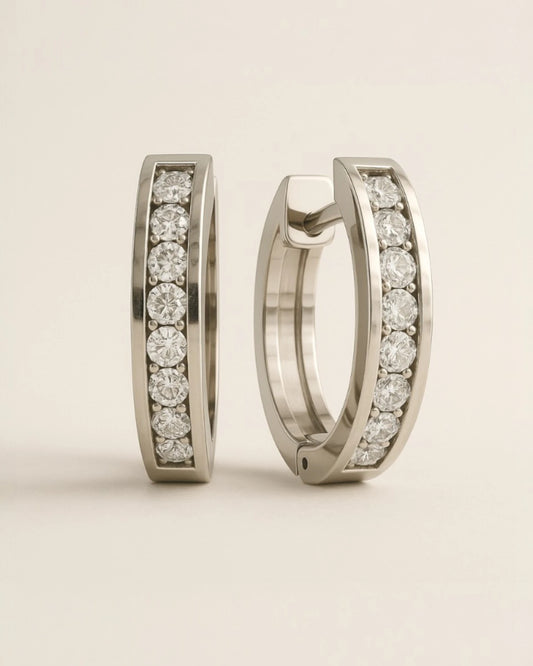 Close up shot of huggie earrings with 0.17 Carat TW of diamonds.
