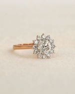 Diamond ring on a beige fabric background.