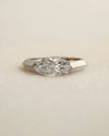 Marquise cut diamond bezel ring in white gold on white background.