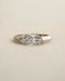 Marquise cut diamond bezel ring in white gold on white background.