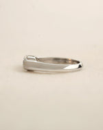 Side view of marquise cut diamond bezel ring in white gold. 