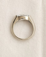 Close up shot of marquise cut diamond bezel ring in white gold. 