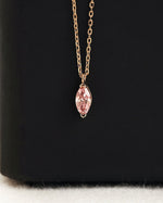 Close up shot of marquise cut lab diamond solitaire pendant necklace in yellow gold.