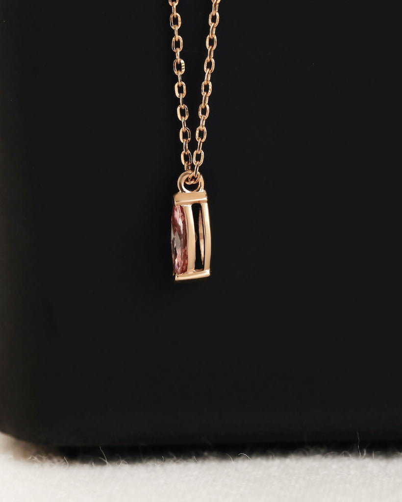 Close up shot of marquise cut lab diamond solitaire pendant necklace in yellow gold.