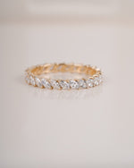 Close up shot of marquise eternity ring in yellow gold.