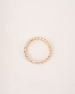  Close up shot of marquise eternity ring in yellow gold.