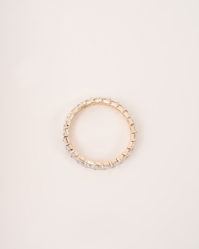  Close up shot of marquise eternity ring in yellow gold.