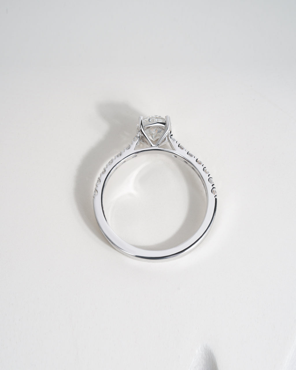 Close up shot of oval cut lab grown diamond engagement ring in white gold.