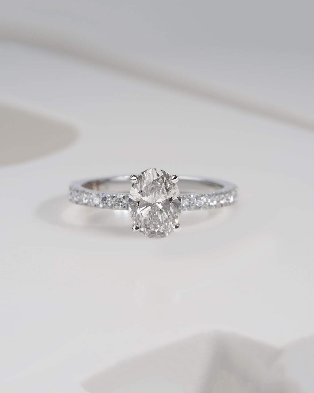 Close up shot of oval cut lab grown diamond engagement ring in white gold.