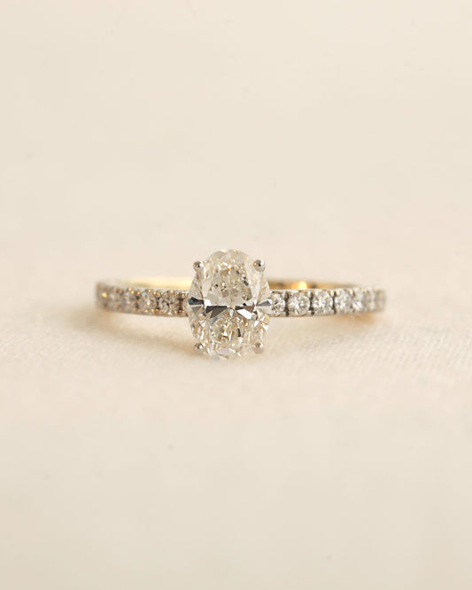 Close u shot of oval cut lab-grown diamond engagement ring in yellow gold.
