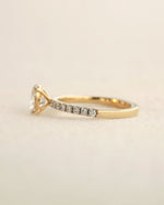 Side view of oval cut lab-grown diamond engagement ring in yellow gold.

