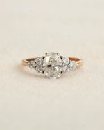 Close u shot of oval cut diamond engagement ring in rose gold.
