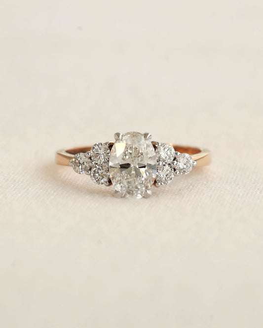 Close u shot of oval cut diamond engagement ring in rose gold.
