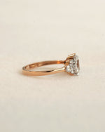 Side view of oval cut diamond engagement ring in rose gold.