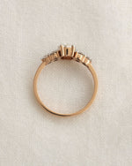 Close up shot of oval cut diamond engagement ring in rose gold.