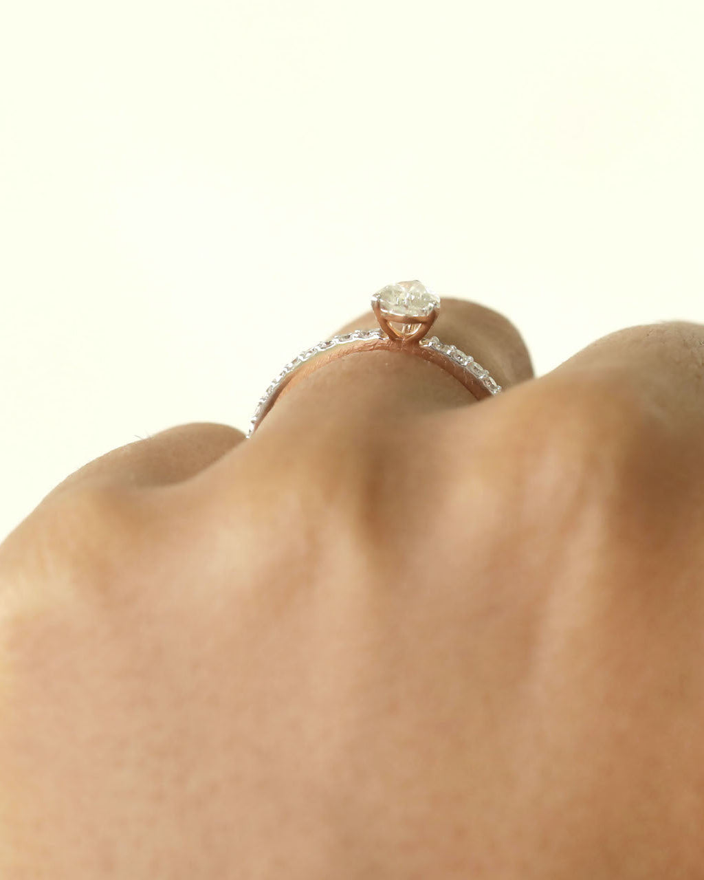 Hand wearing pear cut lab-grown diamond ring. 