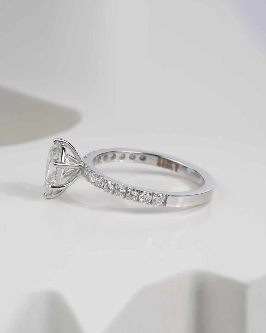 Side view of pear cut lab grown diamond engagement ring in white gold.