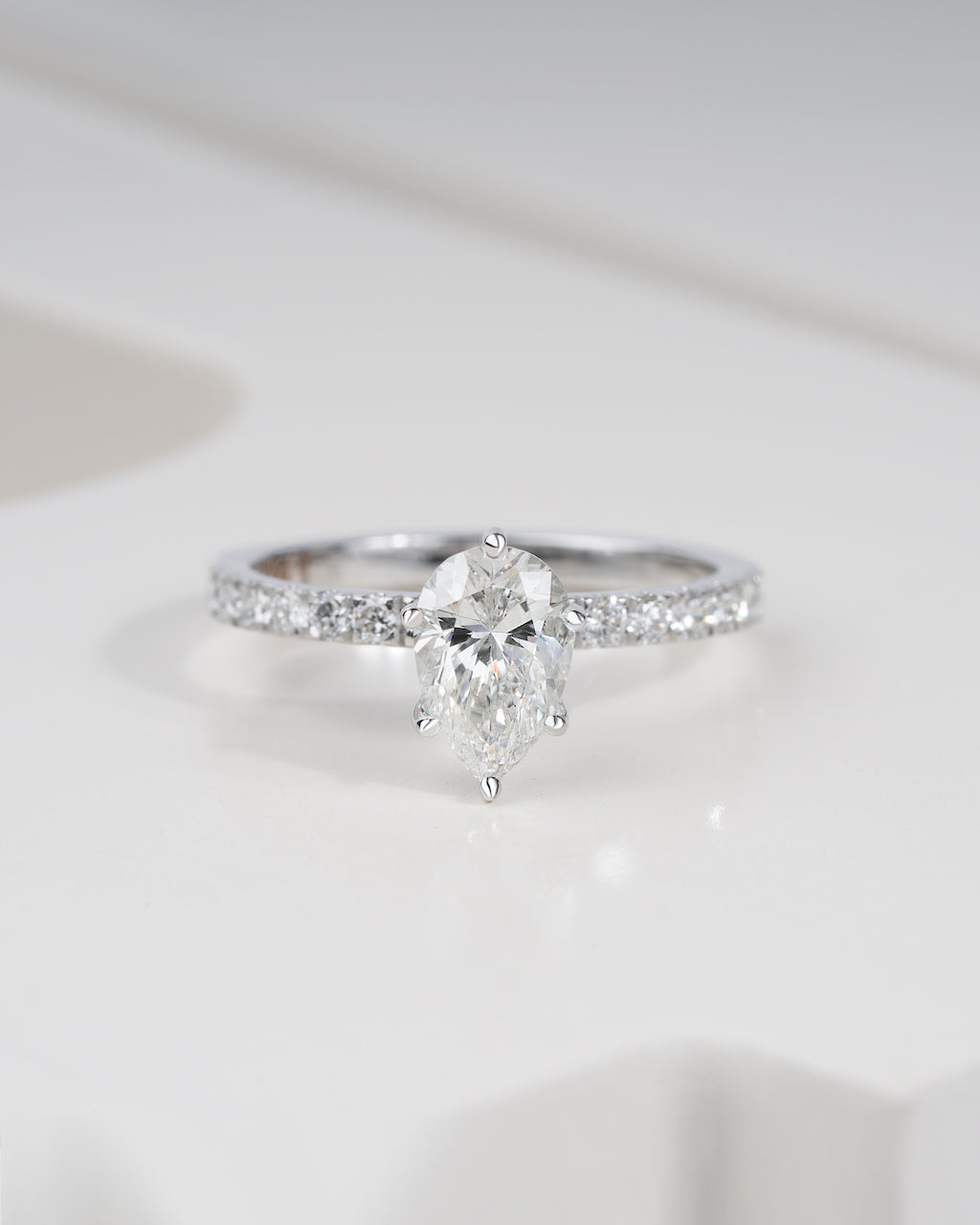 Close up shot of pear cut lab grown diamond engagement ring in white gold.
