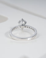 Close up shot of pear cut lab grown diamond engagement ring in white gold.