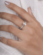  Hand wearing pear cut lab grown diamond engagement ring in white gold.

