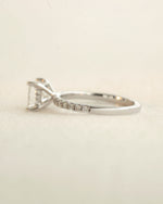 Side view of princess cut diamond engagement ring displayed on a white background.