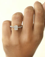 Diamond ring on a hand against a white background