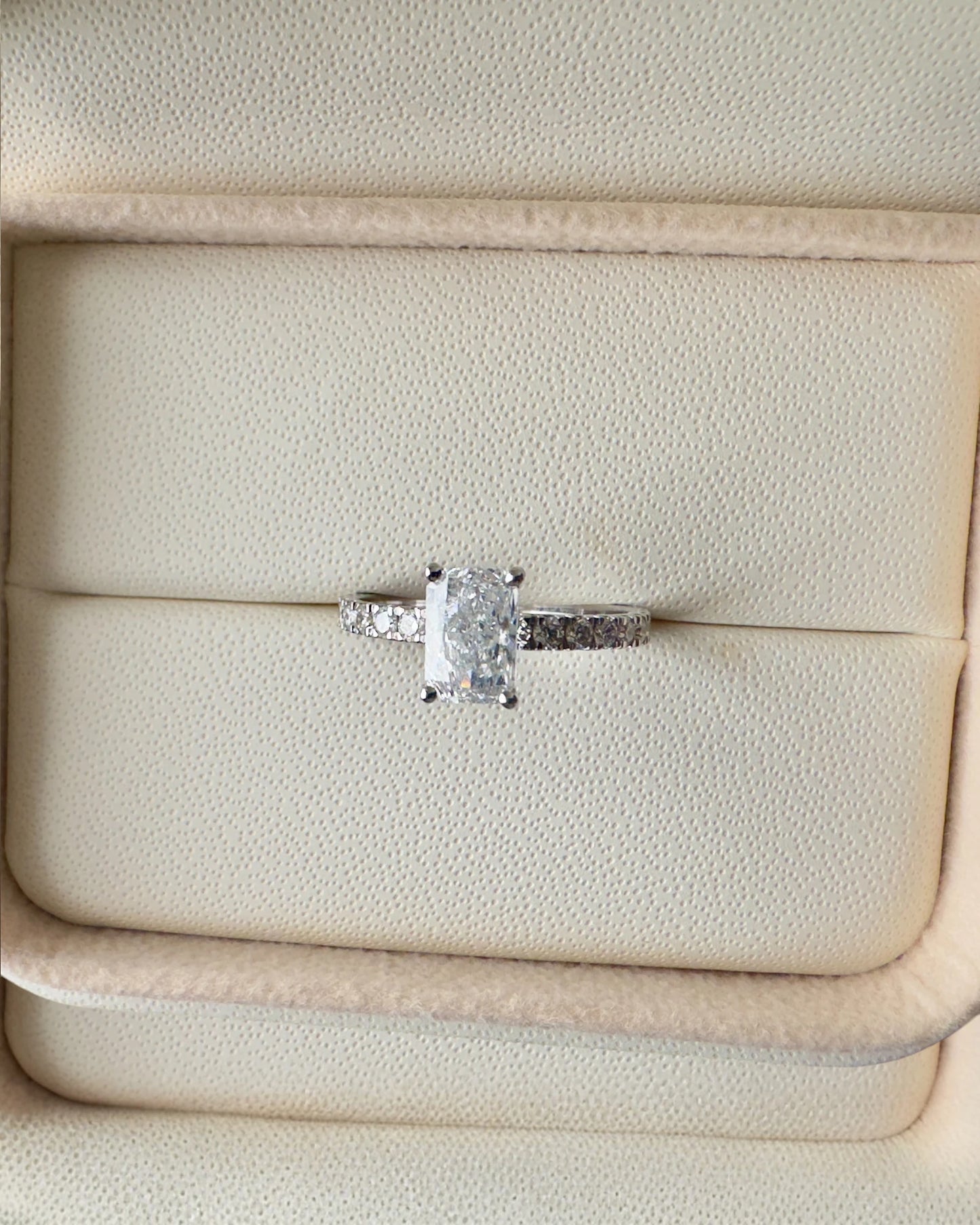 Close up of radiant cut diamond ring.