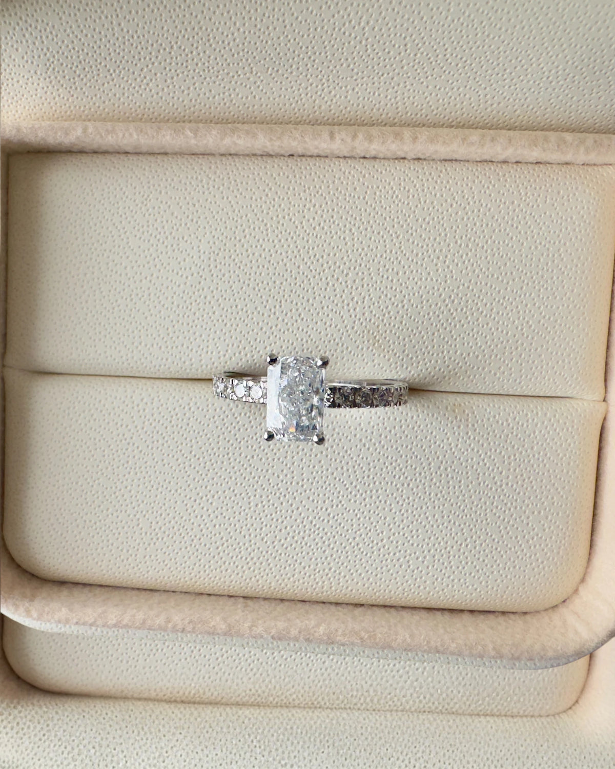 Close up of radiant cut diamond ring.