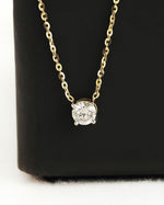 Close up shot of round cut lab diamond solitaire pendant necklace in yellow gold.
