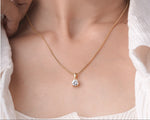 Round cut lab grown diamond solitaire pendant styled on a chain, alternate view.
