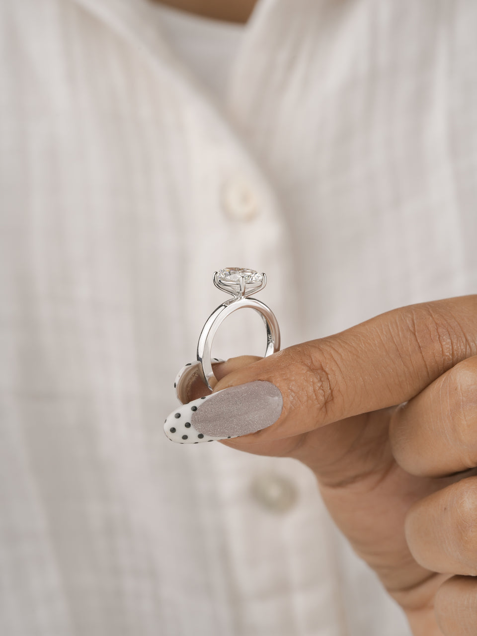 3ct oval lab-grown diamond engagement ring, close-up of the slim white gold band