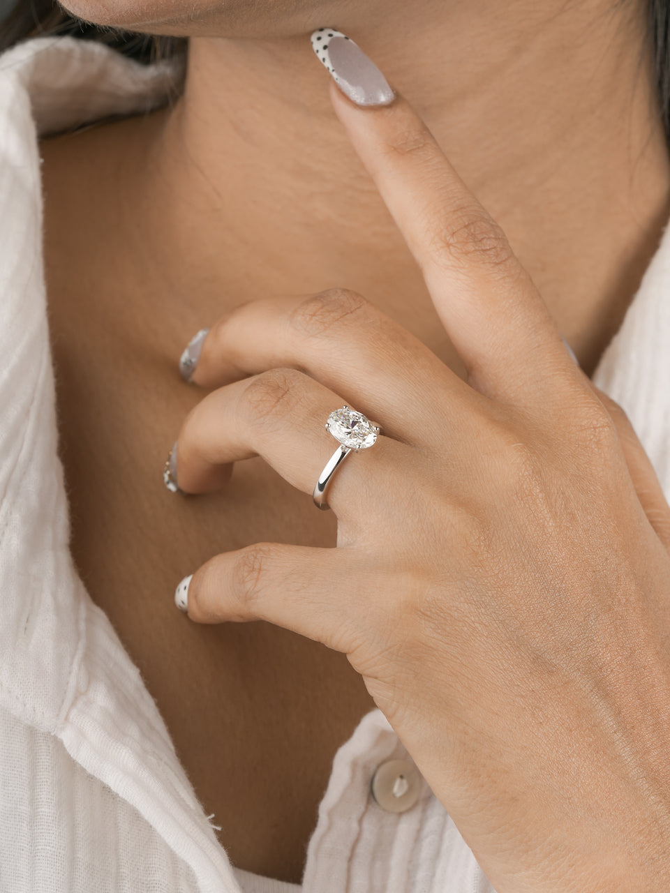 3ct oval lab-grown diamond engagement ring in white gold, worn on hand