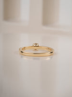 0.30ct round brilliant diamond solitaire engagement ring, close-up of the slim yellow gold band