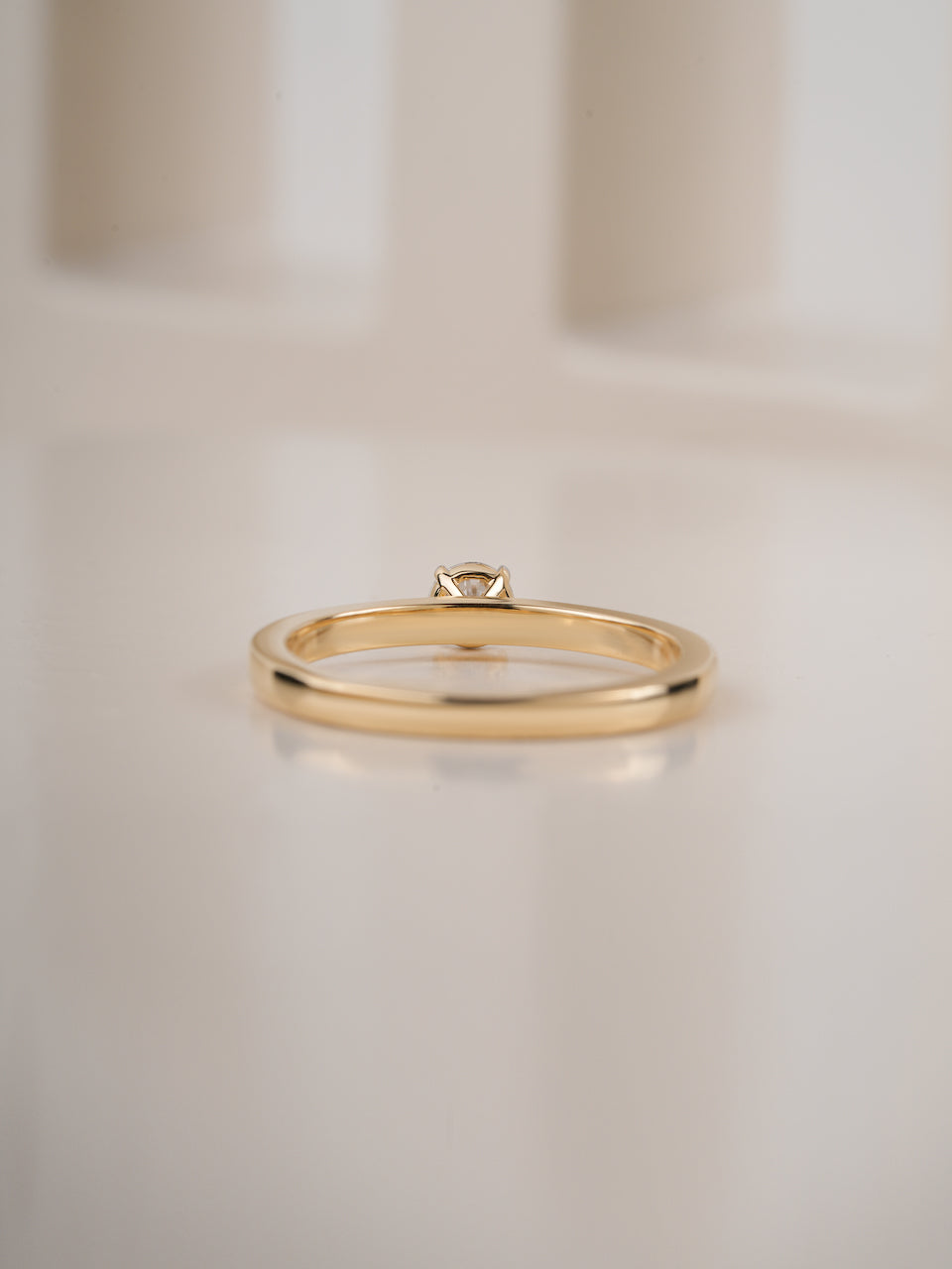0.30ct round brilliant diamond solitaire engagement ring, close-up of the slim yellow gold band