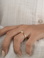 0.30ct round brilliant diamond solitaire engagement ring in yellow gold, styled lifestyle shot