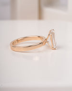 4 ct emerald cut lab grown diamond engagement ring on finger close up LAGANI