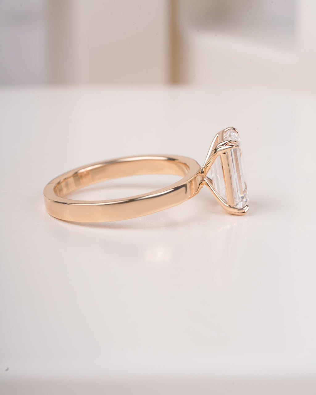 4 ct emerald cut lab grown diamond engagement ring on finger close up LAGANI