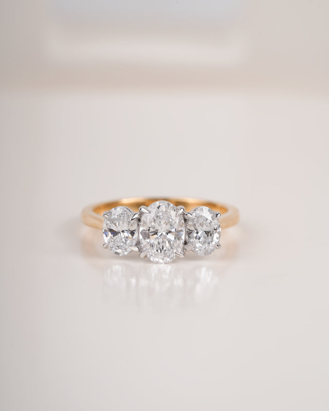 Close up shot of three stone diamond ring.