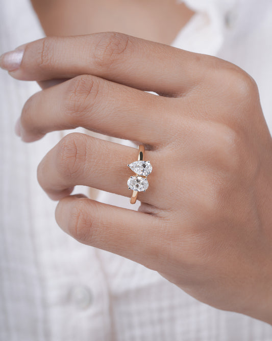 Close-up of a hand wearing a diamond ring on a blurred background