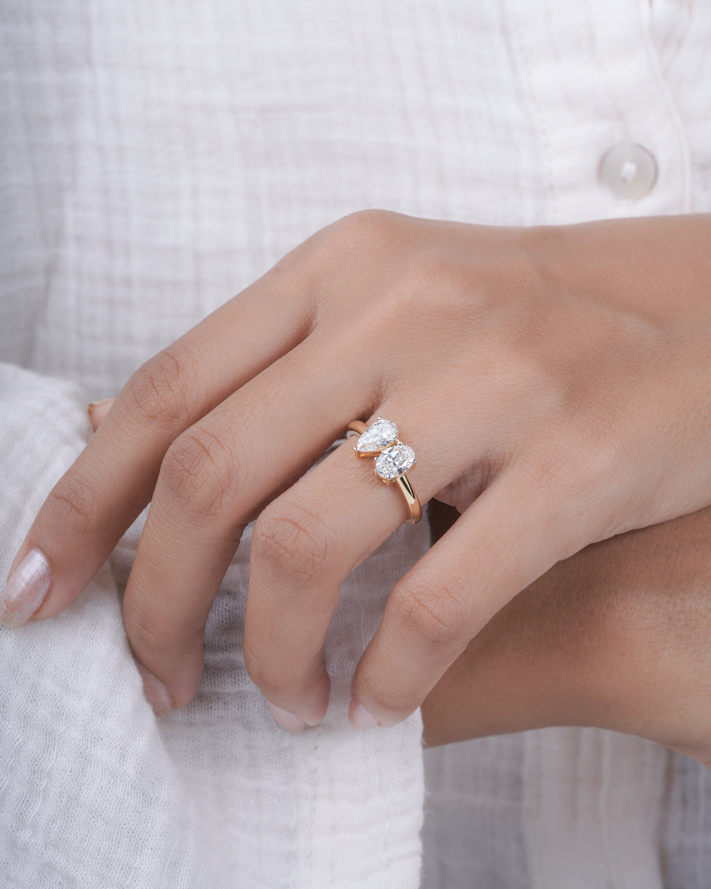 Close-up of a hand wearing a diamond ring on a blurred background