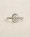 Close up shot of white gold oval halo engagement ring.