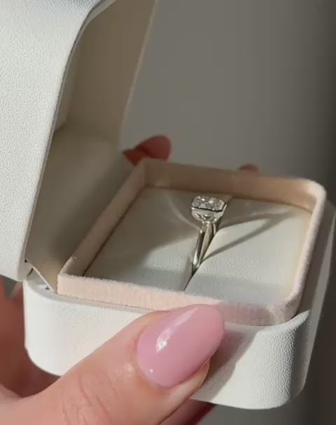 Close up of  radiant cut diamond bezel ring in white gold.